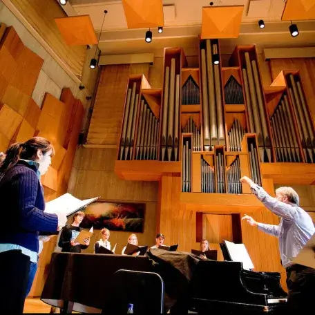 Students perform a choral work.