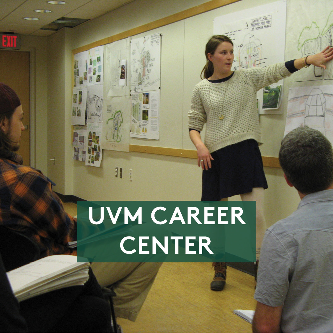 Person standing next to a Career Center display table, text reads "UVM Career Center"