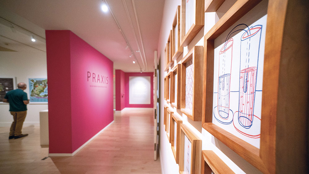 entry way to the praxis art gallery with artwork on the walls