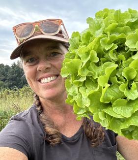 KD with leafy greens in a field.