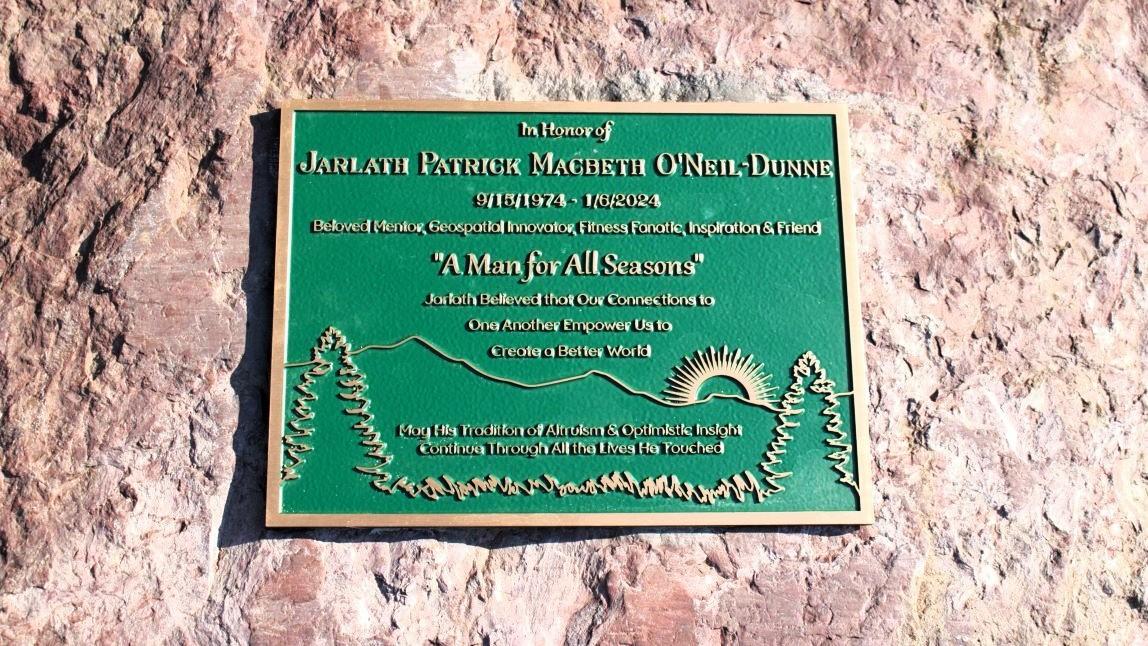 A plaque marking the memorial trees planted next to the Aiken Center in memory of Jarlath O'Neil-Dunne