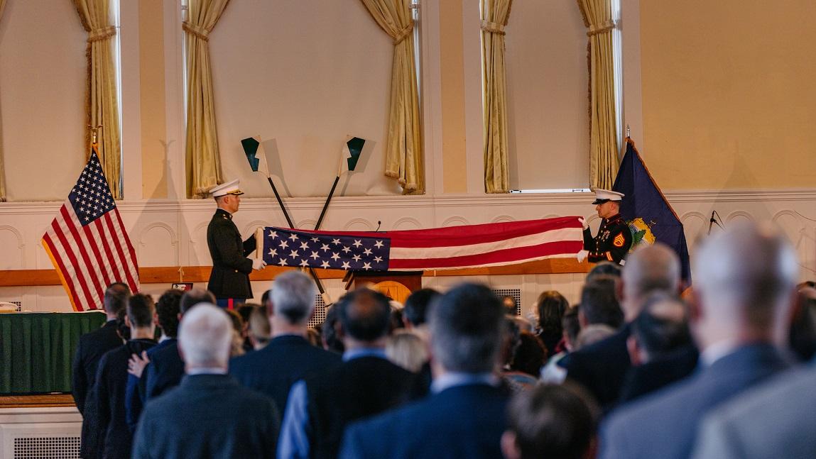 Two marines unfurling a large American flag at the memorial service for Jarlath O'Neil-Dunne