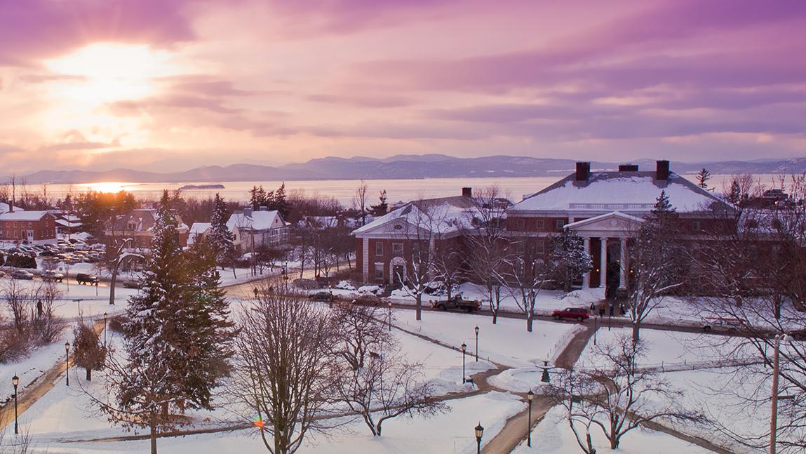 A pink and purple sunset view on the snowy UVM campus