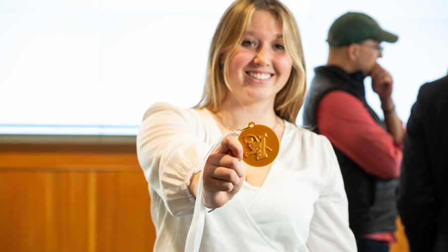 Pippa Scott holds up her first place medal