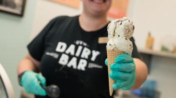 Person holding out an ice cream cone