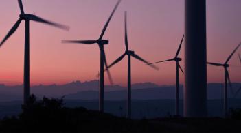 Wind Energy Farm Over a Mountain Sunset 