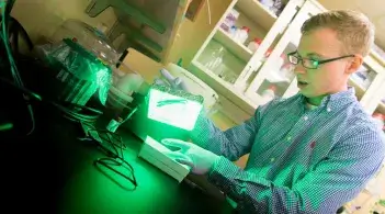 A CEMS student works in a biomedical lab