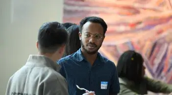Two students having a discussion at a Speciality sibs meet and greet.