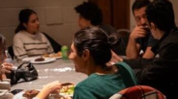 Students talk around a table at the Interfaith Center