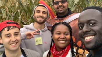 group of students goofing off in a corn field