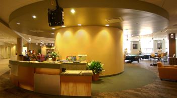 A wide angle photo of one of the Davis Center student help desks and lounging seating behind it