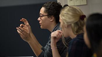 Student having conversation in a classroom 