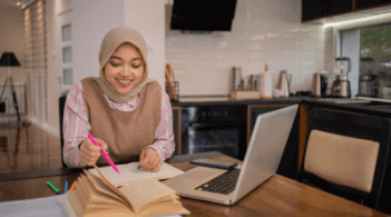 Woman studying from home with laptop