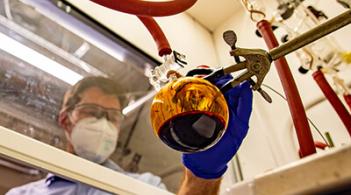 Researcher wearing a lab coat while working in a laboratory setting.