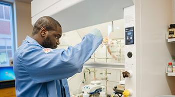 A man in a lab coat conducting experiments in a laboratory