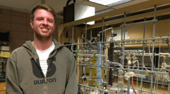 Stephen Van Which posing next to his lab equipment