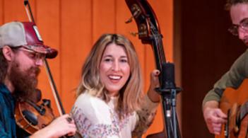 Three musicians performing in stage