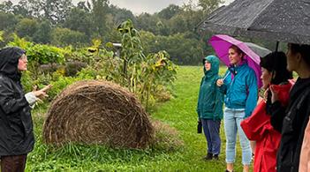 UVM students visit a local farm to learn about refugee agriculture as part of their study of immigrants, diasporas, and the meaning of food and foodways