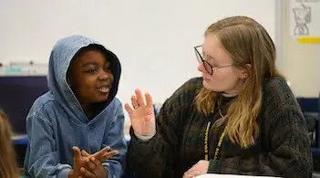 a teacher and young student work together