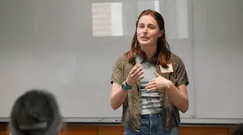 student presenting before an audience