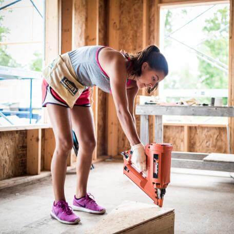 A student uses a power tool during Alternative Spring Break 