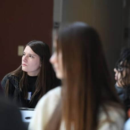 Two prospective students listen intently