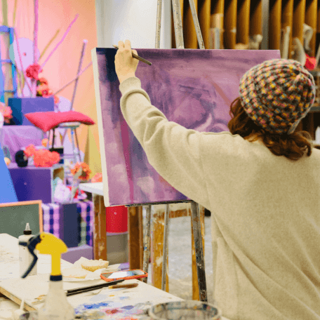 Student painting a colorful still life