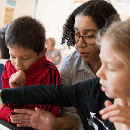 A student works with kindergarteners