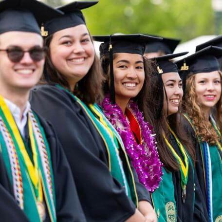 students in regalia at commencement.