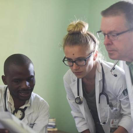 three doctors reviewing document