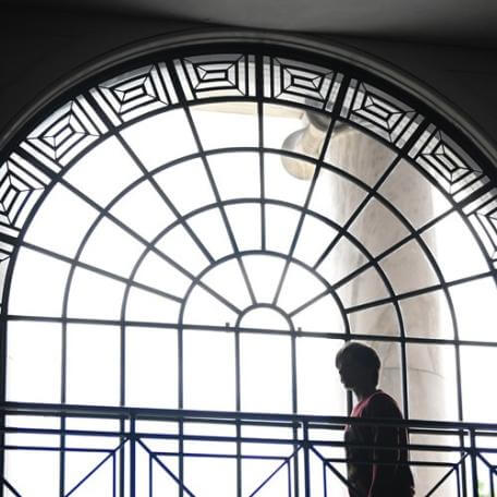 silhouette of person in front of decorative window