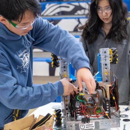 Students make adjustments to their robot