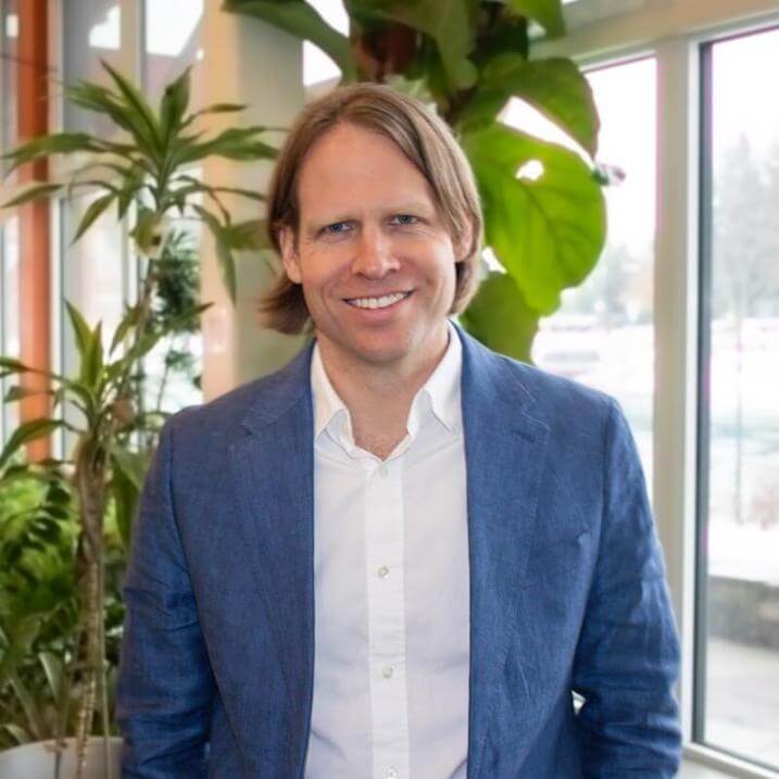 Eric Roy wearing a blue jacket and white shirt