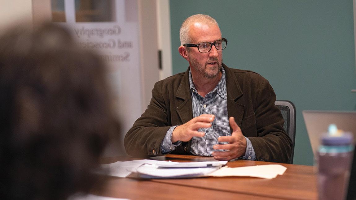 mark usher orates in front of a classroom