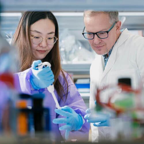 A student and faculty member work in a laboratory.