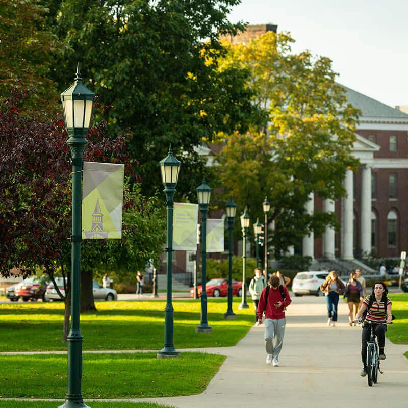 Students walking through the middle of campus, outside