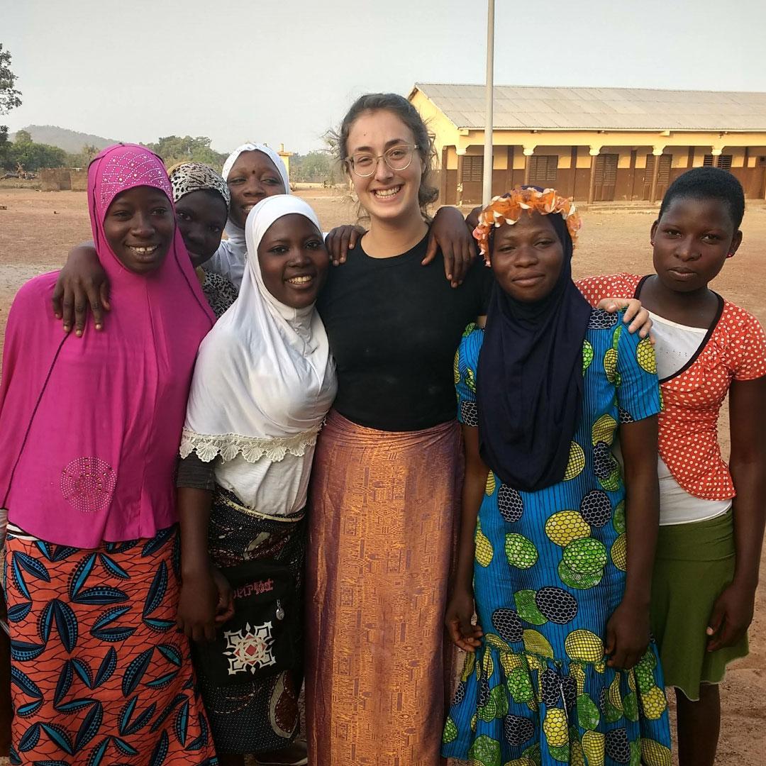 seven individuals smile at the camera