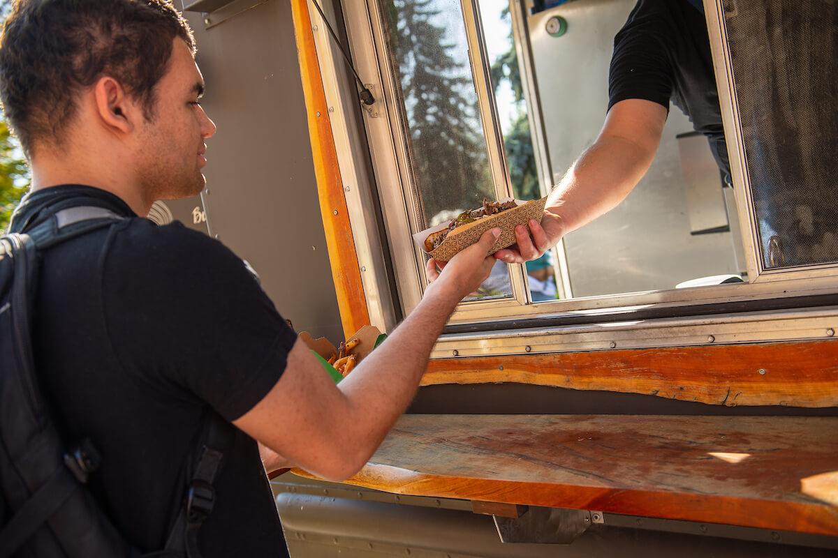 Handing someone food from a food truck