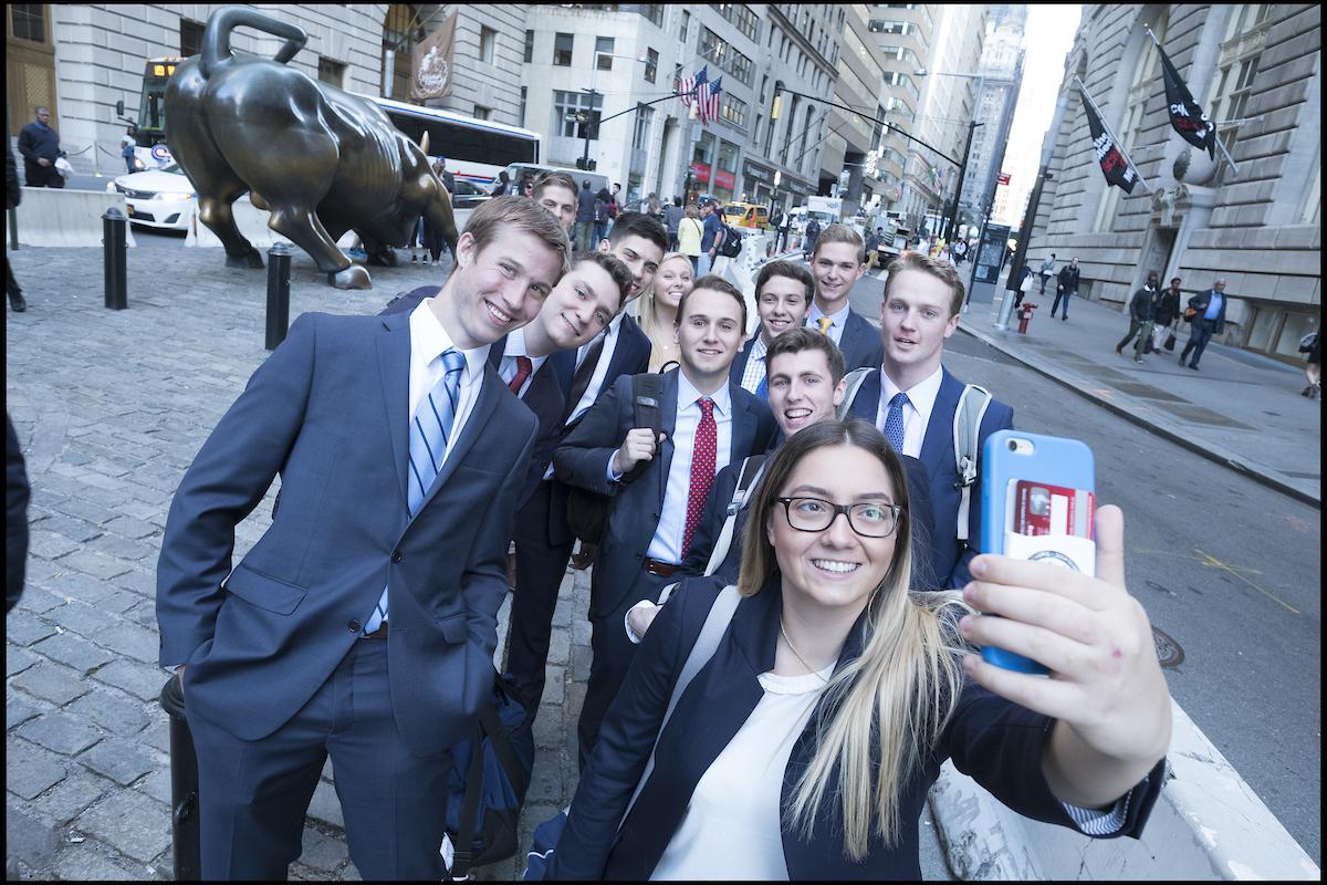 Students wearing business attire take a selfie
