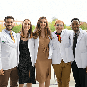 five students arm in arm