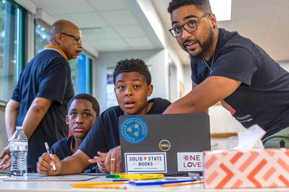 Daniel Fairley teaching a young male student.