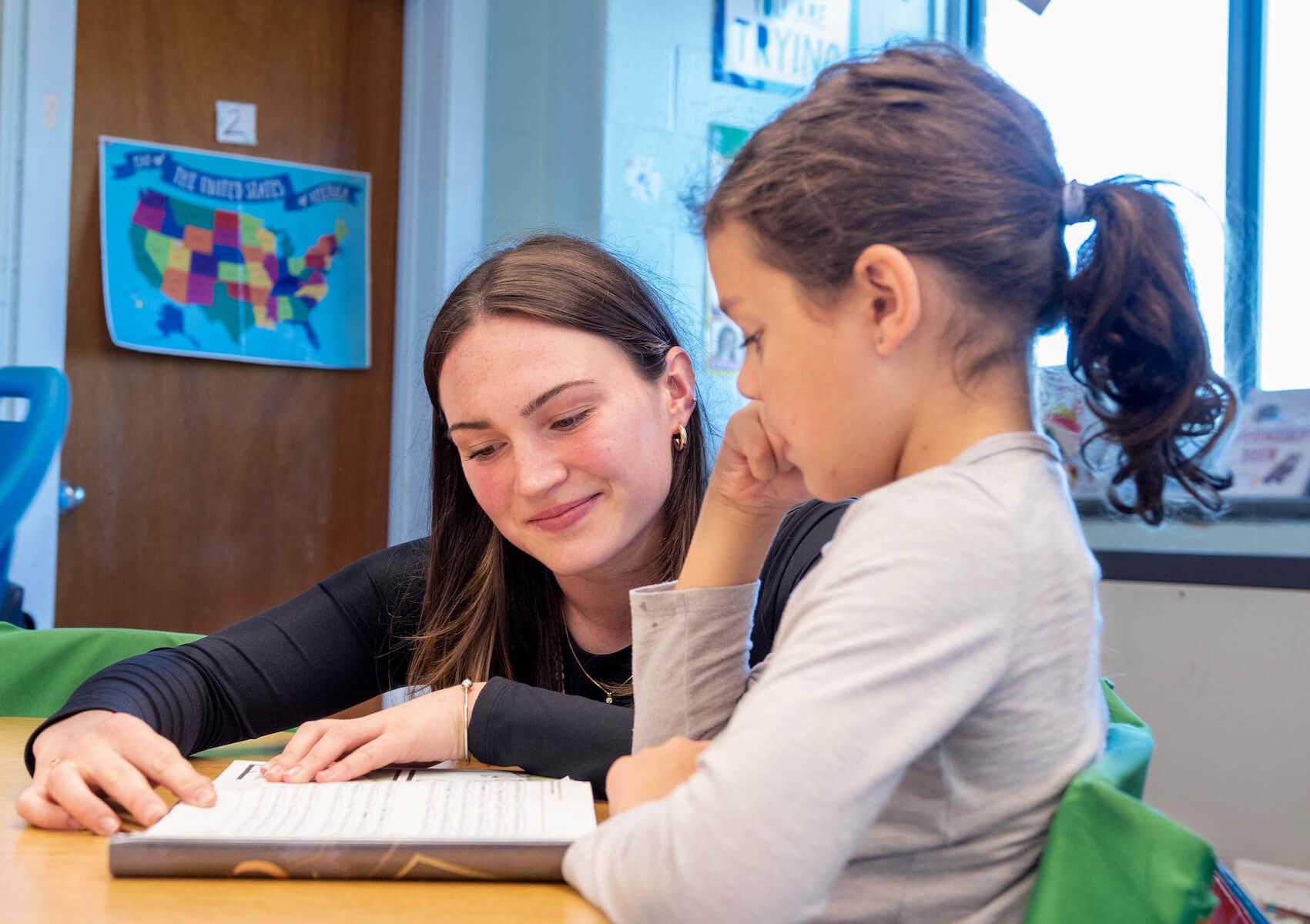 Ella McCarthy teaching a student during her internship.