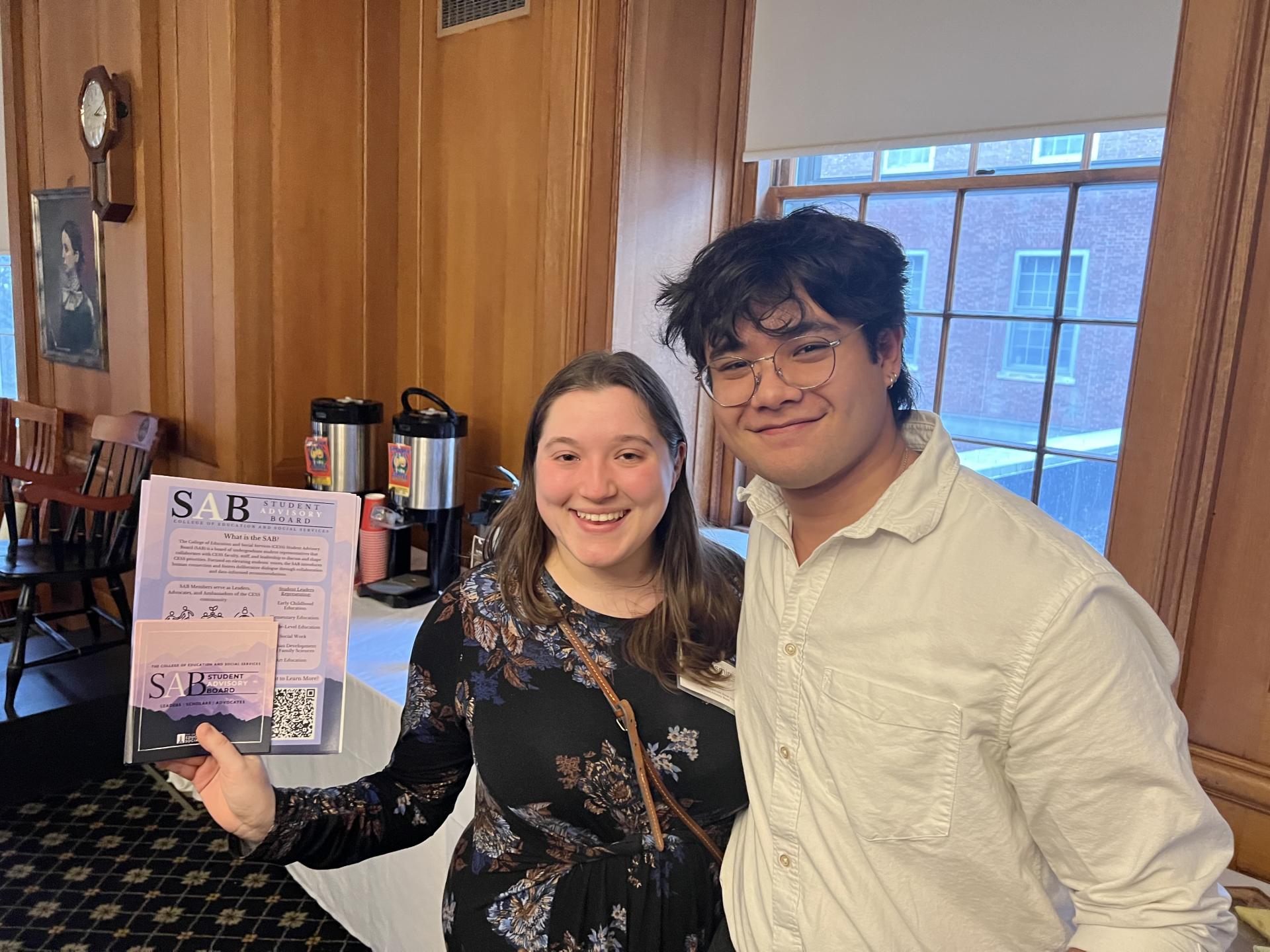 Two CESS Student Advisory Board members at a faculty and staff meeting.
