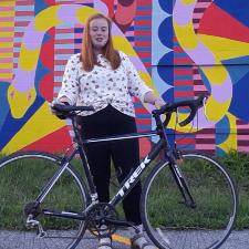 Woman standing next to bike