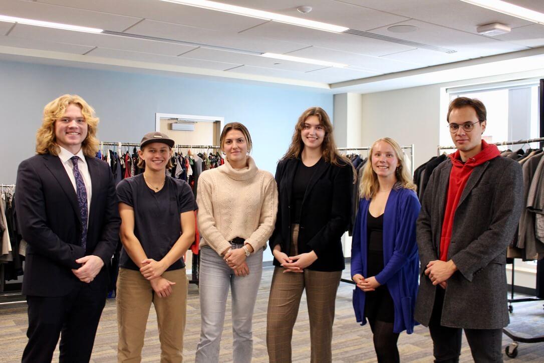 The Grossman Student Advisory Committee (GSAC) poses for a photo at the Professional Business Attire Sale event they host each year.