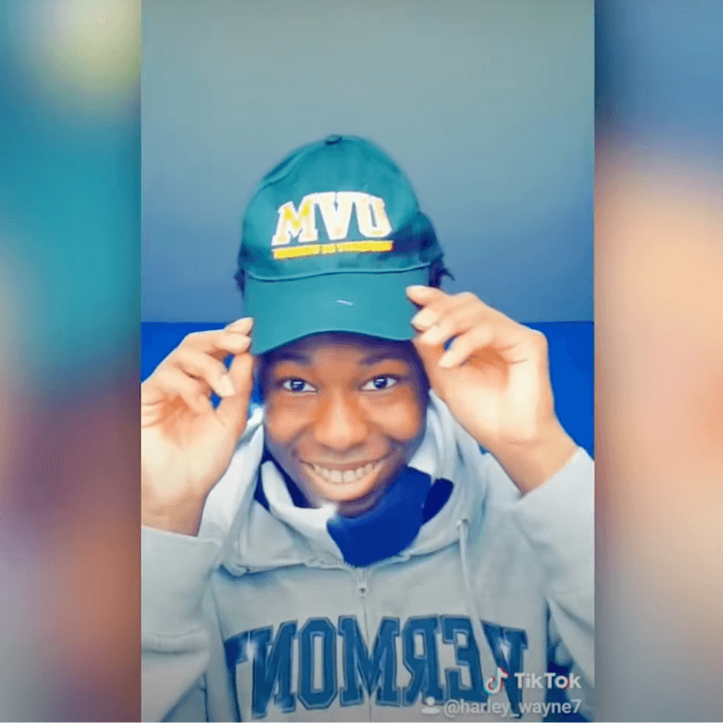 Still from a TikTok video of a student wearing a UVM hat