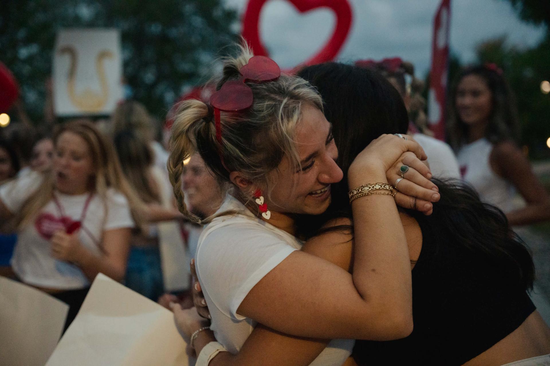Two Sorority Girls hugging after an emotional bid night
