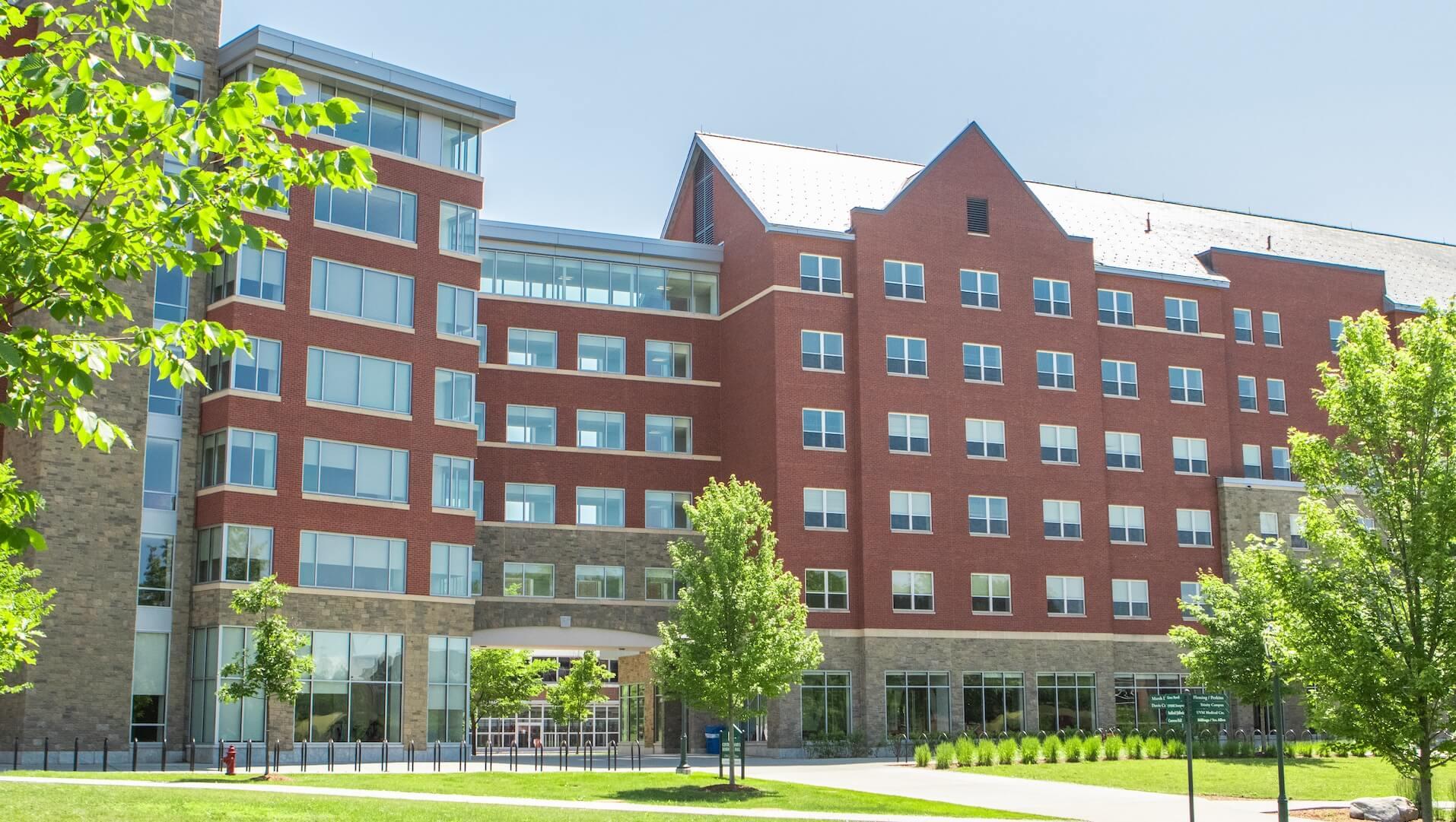 A modern, brick and glass 6-story building. 