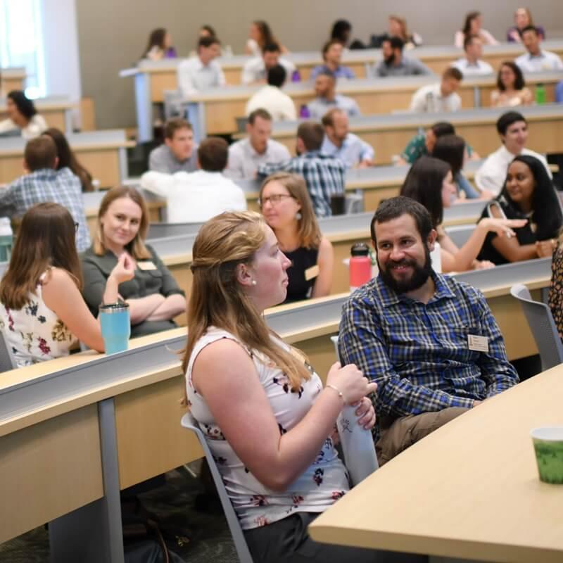 students in classroom talking amongst themselves