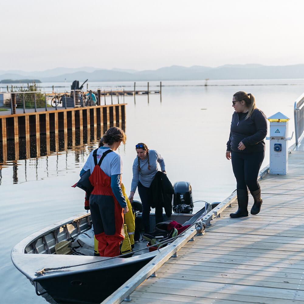 A lake view with people near a small boat